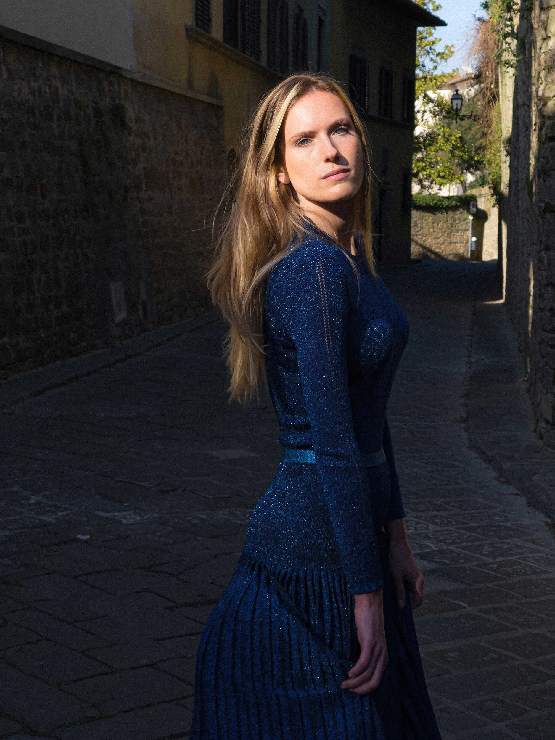 Blonde model in a navy knit dress in a Florence alley, hybrid analog and iPhone photography