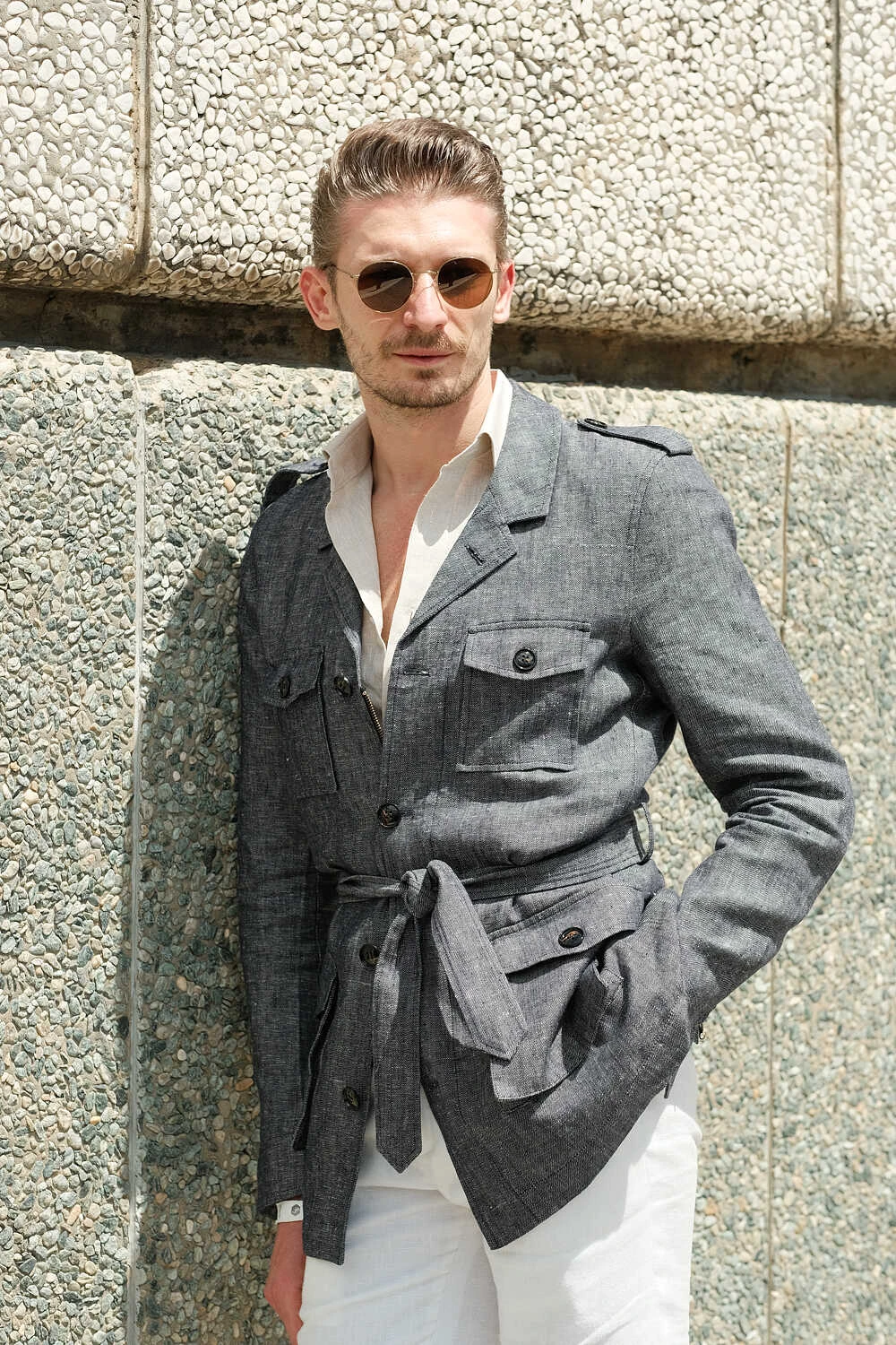 Model in a grey safari jacket and white trousers for Hockerty in Florence