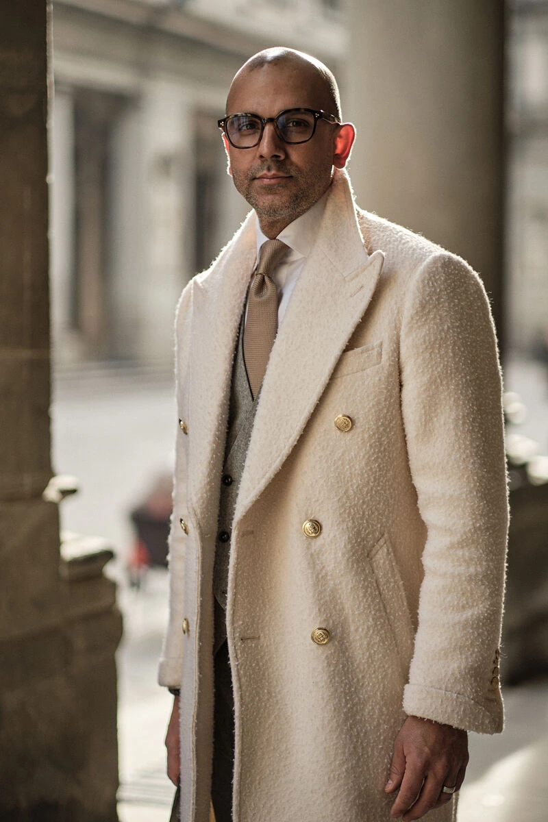 Man in a cream boucle double-breasted coat in a Florence arcade, male fashion street style