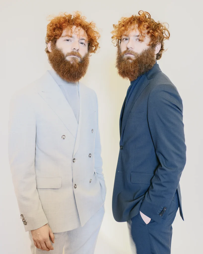 Two red-haired men in cream and blue suits, street style at Pitti Uomo 105 in Florence