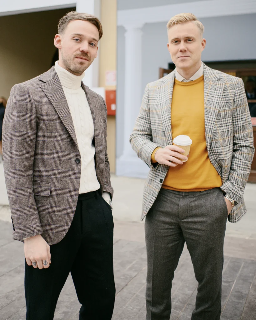 Two men in tweed jackets with a turtleneck and mustard knitwear, street style at Pitti Uomo 105 in Florence