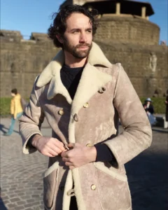 Man in a beige shearling suede coat, street style at Pitti Uomo 105 in Florence