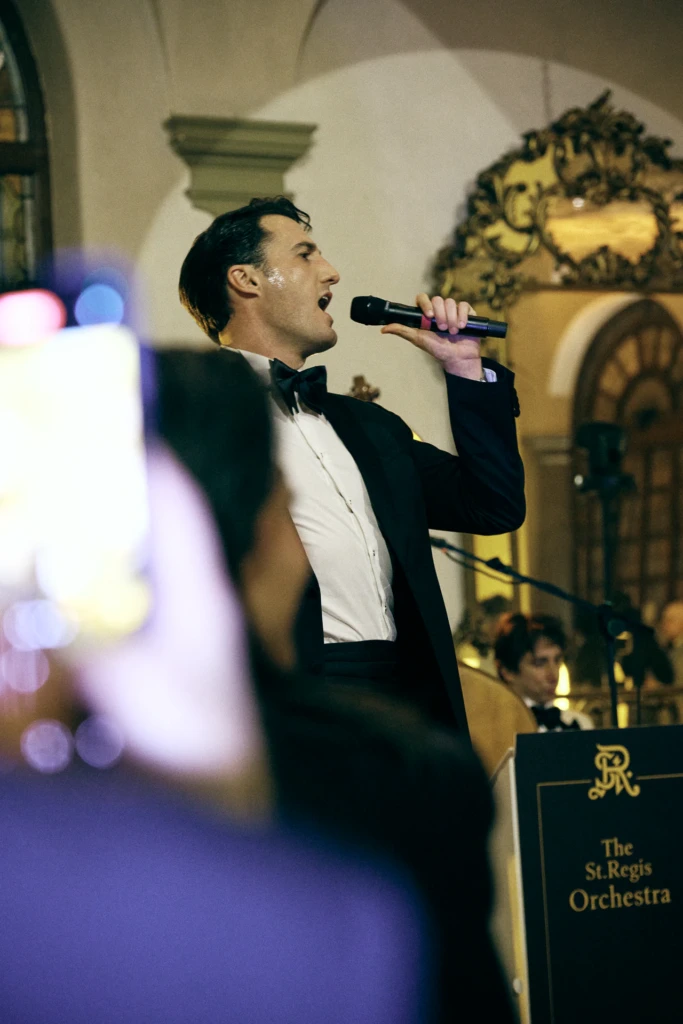 Singer performing with the St. Regis Orchestra at the St. Regis hotel party during Pitti Immagine Uomo 109, Florence