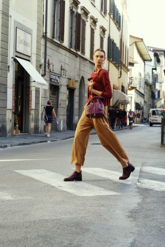 Fashion lifestyle portrait on a sunlit Florence street corner -- fashion lifestyle photography in Florence