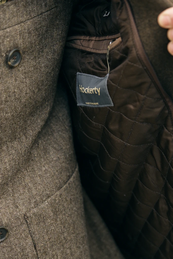 Hockerty menswear editorial photographed by Alessandro Michelazzi at Pitti Immagine Uomo 107 in the streets and pavilions of Florence, look 051.