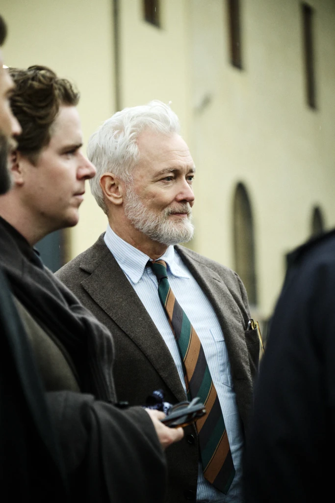 Elderly bearded man with white hair in a brown tweed blazer and striped tie, pen in his breast pocket, Pitti Immagine Uomo 109 fair