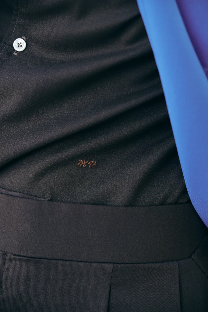 Close-up of a dark suit lining with embroidered monogram initials