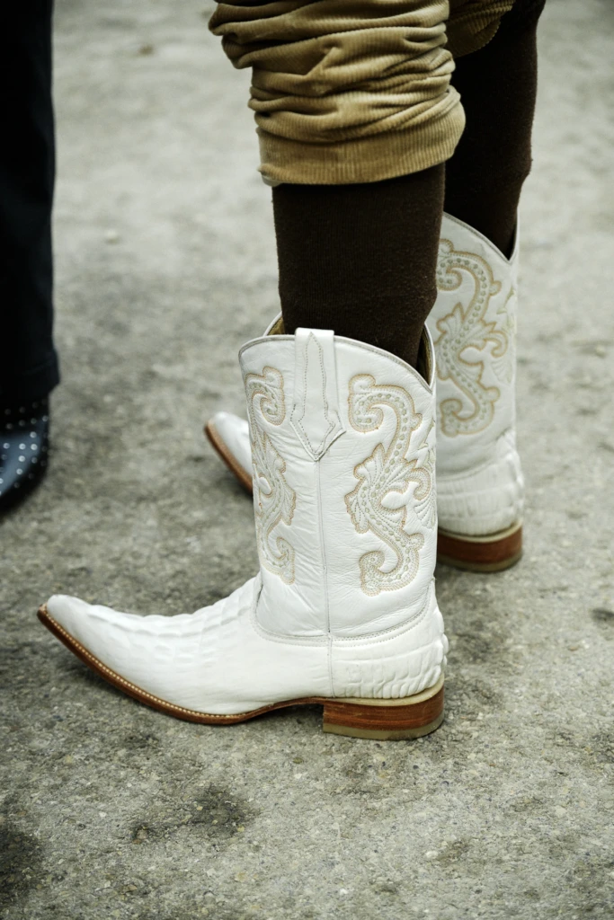 Close-up of white leather cowboy boots with tan floral embroidery, Pitti Immagine Uomo 109 fair, Florence