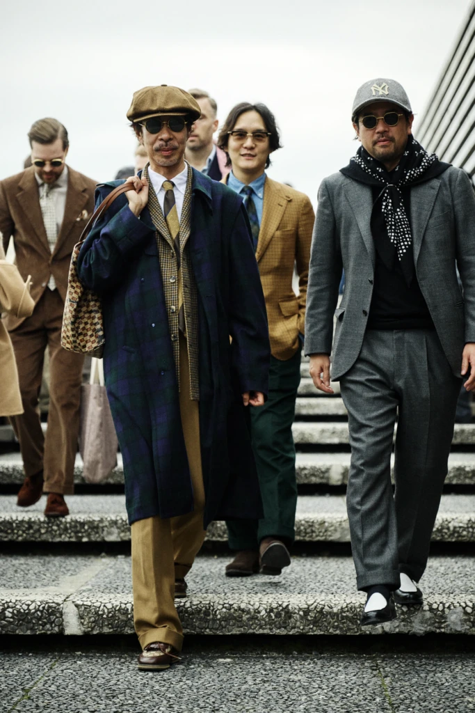 Group of stylish attendees descending the steps at Fortezza da Basso during Pitti Immagine Uomo 109, Florence