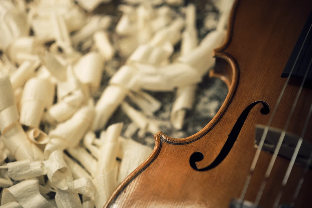 Close-up of violin f-holes being carved, Florence luthier studio