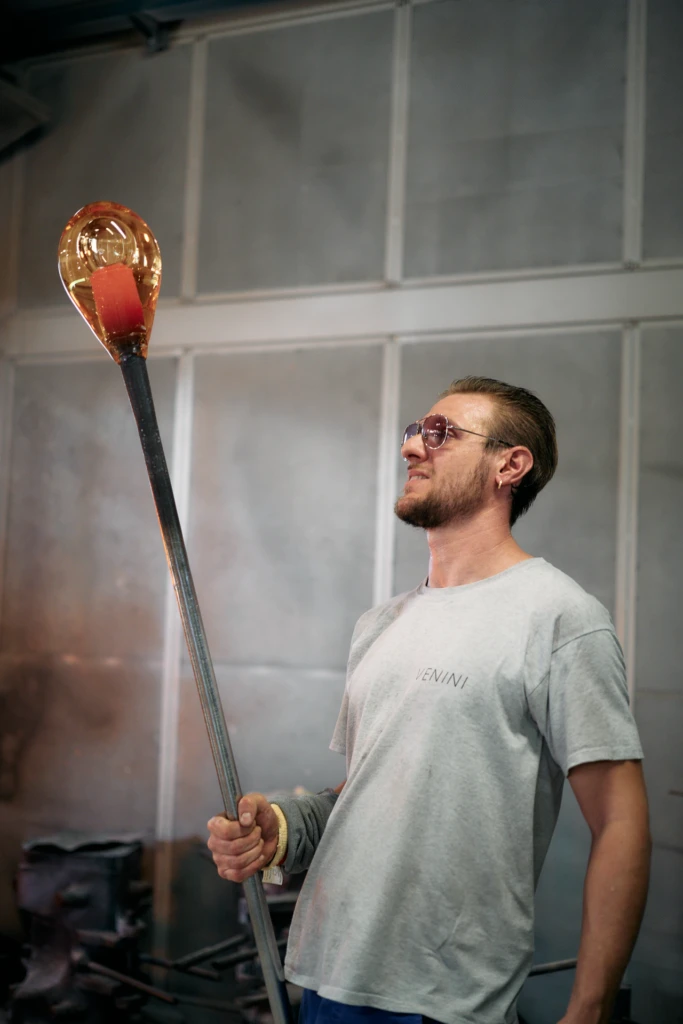Venini Maestro at work with molten glass, Murano foundry