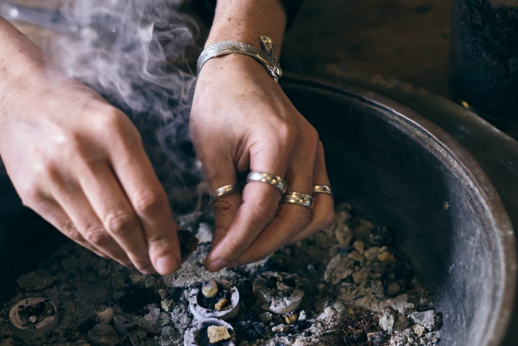 Sileno Cheloni examining a fragrance formula in Florence atelier